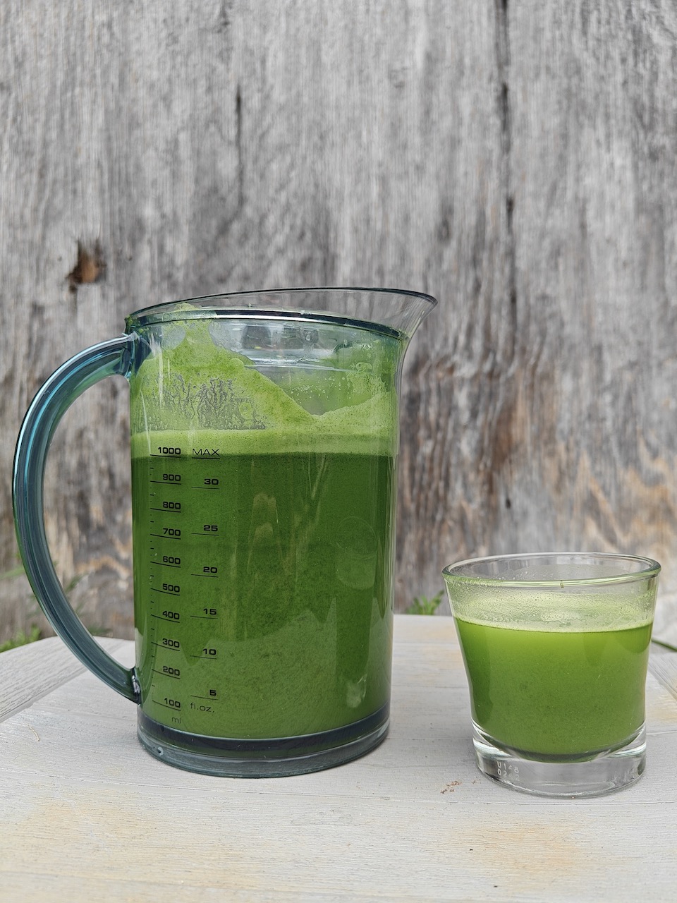 A pitcher and a glass of fresh green juice, highlighting a nutritious drink perfect for a healthy lifestyle